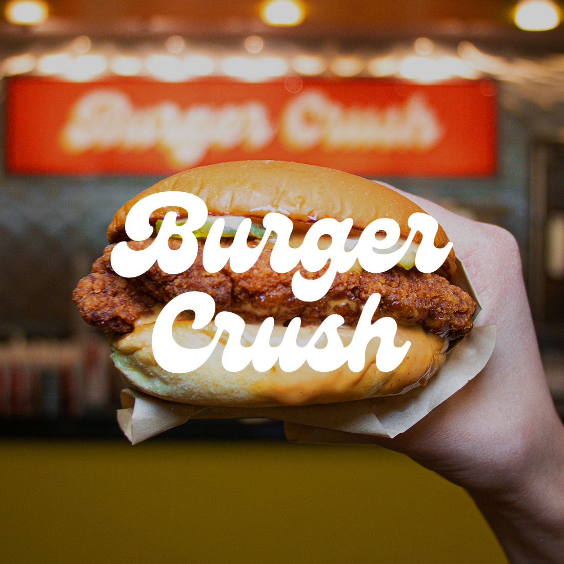 Burger Crush logo over delicious chicken sandwich